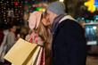 © Dexon Dee - Young affectionate couple kissing tenderly on Christmas street