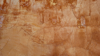 old texture for a cracked and weathered surface from an ancient brown wall facade - rough blank back