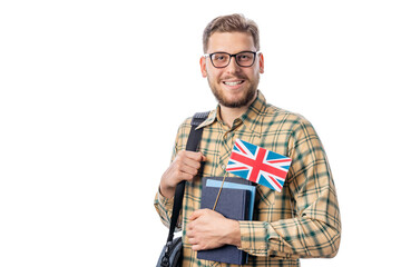 Happy smiling successful male student looking to camera, holding books and British flag, isolated