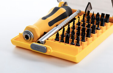 Close -up of interchangeable screwdriver set with different types isolated on white background. Set of working tools