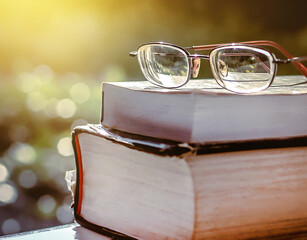Poster - Stack of books in library and blurred bookshelf background and the golden light shines for education and learning into the future
