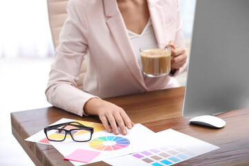 Poster - Female designer working at desk in office, closeup