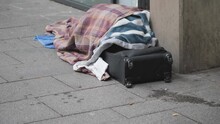 A View Of A Homeless Person Sleeping Rough On The Street.