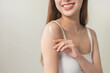 © KMPZZZ - Healthy skin care, beauty asian young woman in bathrobe, towel after shower bath at home, hand in applying, putting moisturizer on her arm. Skin body cream moisturizing lotion, routine in the morning