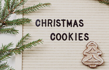 Wall Mural - Christmas cookies. Letter board with words and branches of spruce. Winter concept.