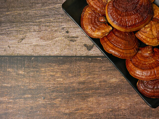 Wall Mural - Lingzhi mushroom on wood table for food or medical concept