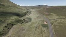 Aerial Follows Car On Highway In South Africa Through Grassland