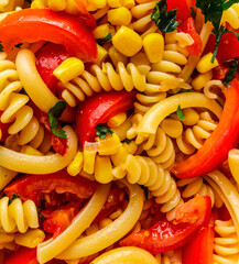 italian salad with pasta , tomatoes and corn close up, food for restaurant and recipe for cooking on a kitchen