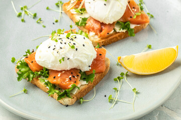 Wall Mural - Poached egg with salmon and guacamole on toast. Delicious breakfast. Food recipe background. Close up
