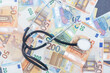 Stethoscope and Euro banknotes, Financial, account, statistics and business data medical health concept.