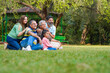 © Niks Ads - Happy indian or asian family sitting at park.