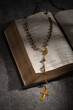  Rosary with cross  on a open holy bible 