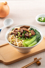 Wall Mural - Beef noodle soup. Taiwanese famous food in a bowl on wooden table.