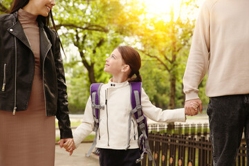 Wall Mural - Parents taking their little daughter to school outdoors