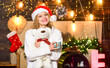 © be free - pleasant evening. xmas mood. Woman toy bear present. girl in santa hat drink tea. coffee time. Cheerful woman in sweater. winter holidays celebration. happy new year. christmas preparation