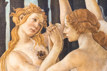 Close-up on medieval fresco showing two blond girls holding hands