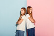 © Lustre Art Group  - Sad young girls, two sisters friends in casual style clothes isolated over pink-blue studio background. Fashion, relationship, emotions, beauty and youth