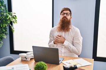 Wall Mural - Young redhead man business worker suffering heart attack working at office