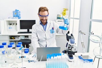 Sticker - Middle age hispanic man wearing scientist uniform working at laboratory