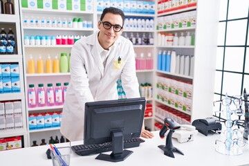 Sticker - Young hispanic man pharmacist smiling confident using computer at pharmacy