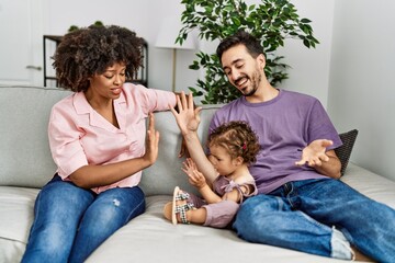 Canvas Print - Couple and daughter smiling confident sitting on sofa at home