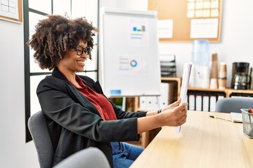 Sticker - Young african american woman smiling confident holding documents at office