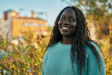 Young african woman smiling happy at the park