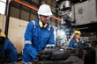 © tigercat_lpg - An industrial worker in protective safety uniform and hardhat, a Professional Caucasian male engineer works with metalwork machines in lathe manufacturing factory, mechanical production occupation.
