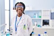 African american woman scientist smiling confident standing at laboratory