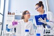 © Krakenimages.com - Woman and girl wearing scientist uniform working at laboratory
