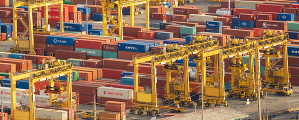 Wall Mural - Aerial view of container cargo ship in the export and import business and logistics international goods in urban city. Shipping to the harbour by crane in Bangkok harbour, Thailand.