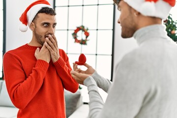 Sticker - Two hispanic men couple surprise with engagement ring standing by christmas decor at home