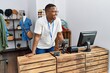 © Krakenimages.com - Young african man working as shop assistance at retail shop