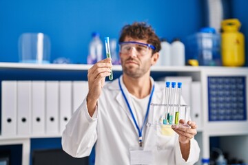 Sticker - Young man scientist holding test tubes at laboratory