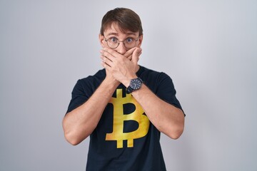 Sticker - Caucasian blond man wearing bitcoin t shirt shocked covering mouth with hands for mistake. secret concept.