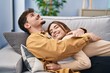 © Krakenimages.com - Mand and woman couple hugging each other lying on sofa at home
