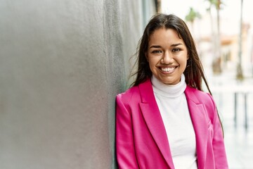 Canvas Print - Young latin woman smiling confident standing at street