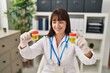 © Krakenimages.com - Young beautiful hispanic woman doctor comparing urine test tubes at clinic