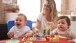 © Krakenimages.com - Teacher and preschool students playing with toys sitting on table at kindergarten