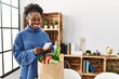 © Krakenimages.com - African american woman smiling confident reading food receipt at home