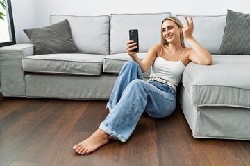 Canvas Print - Young blonde woman smiling confident making selfie by the smartphone at home