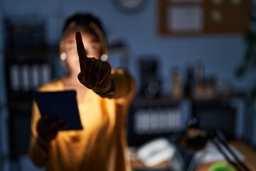 Sticker - African american woman with braids working at the office at night with tablet pointing with finger up and angry expression, showing no gesture