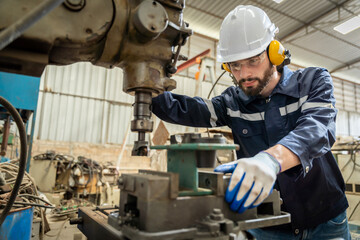 Team of engineers practicing maintenance Taking care and practicing maintenance of old machines in the factory so that they can be used continuously.