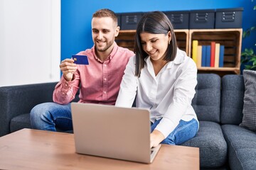 Poster - Man and woman couple using laptop and credit card at home