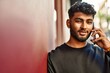 © Krakenimages.com - Young arab man smiling confident talking on the smartphone at street