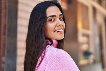 Wall Mural - Young hispanic woman smiling confident standing at street