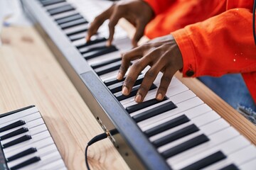 Sticker - African american man musician playing piano keyboard at music studio