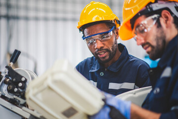 engineers team mechanic using computer controller robotic arm for welding steel in steel factory wor