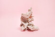 Crumpled paper ball staying on pink background