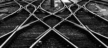 Railway Track Panorama At Frankfurt Main Station Germany. Geometrical Lines In Black And White. Contrasting Steel Of Switches, Crossings, Railway Sleepers, Gravel Forming Symmetrical Structures.
